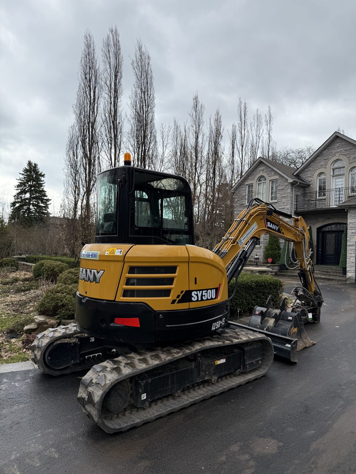 Mini excavator delivered to a residential job in the west GTA, the most-booked rental in Burlington and Milton