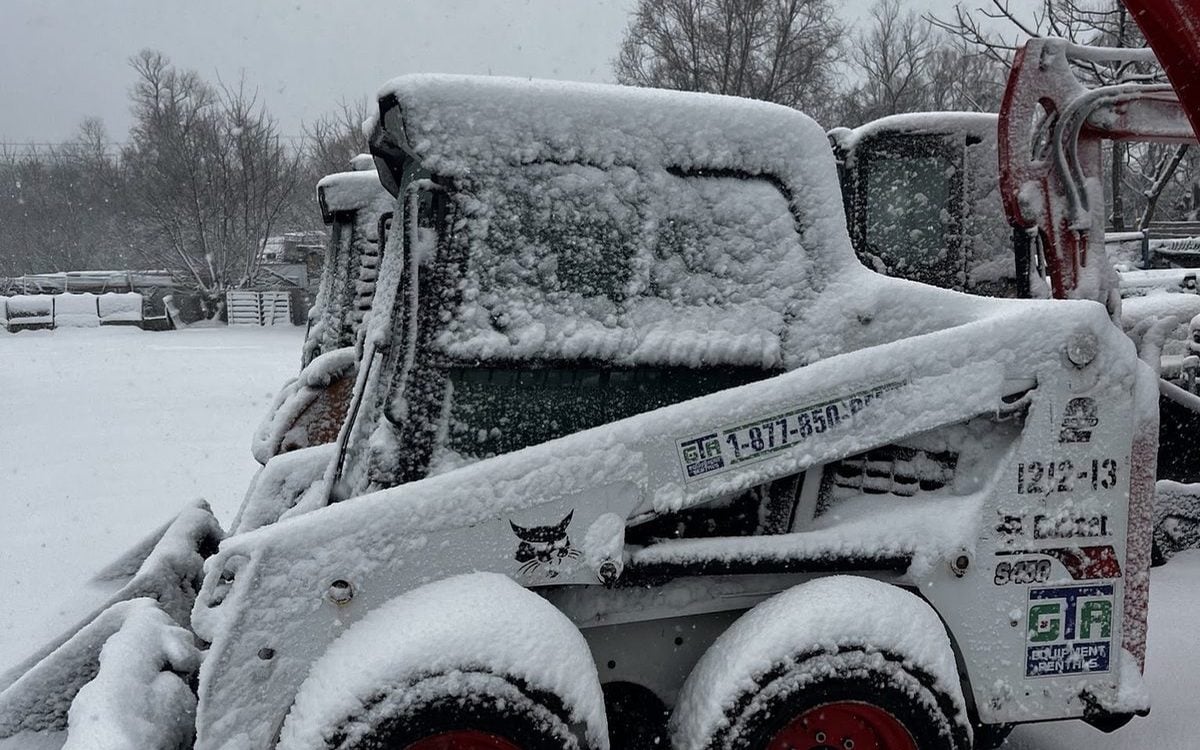 Bobcat skid steer from GTA Equipment Rentals covered in fresh snow on a west GTA jobsite in winter