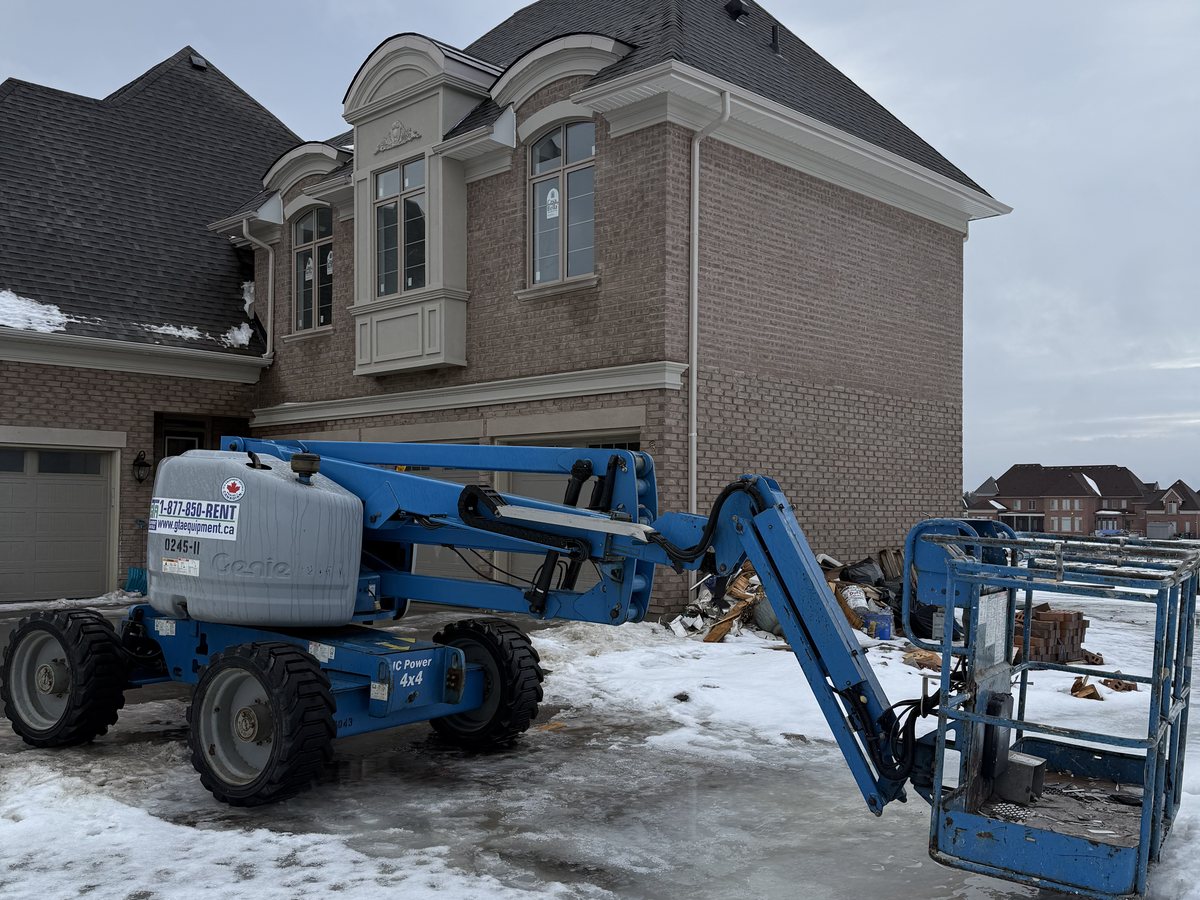 Genie articulating boom lift from GTA Equipment Rentals on a residential build near Burlington