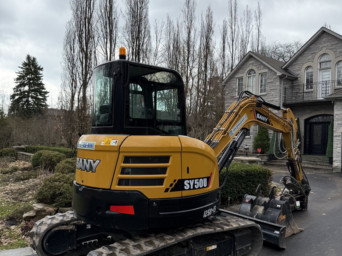 SANY mini excavator on a residential driveway job near Burlington