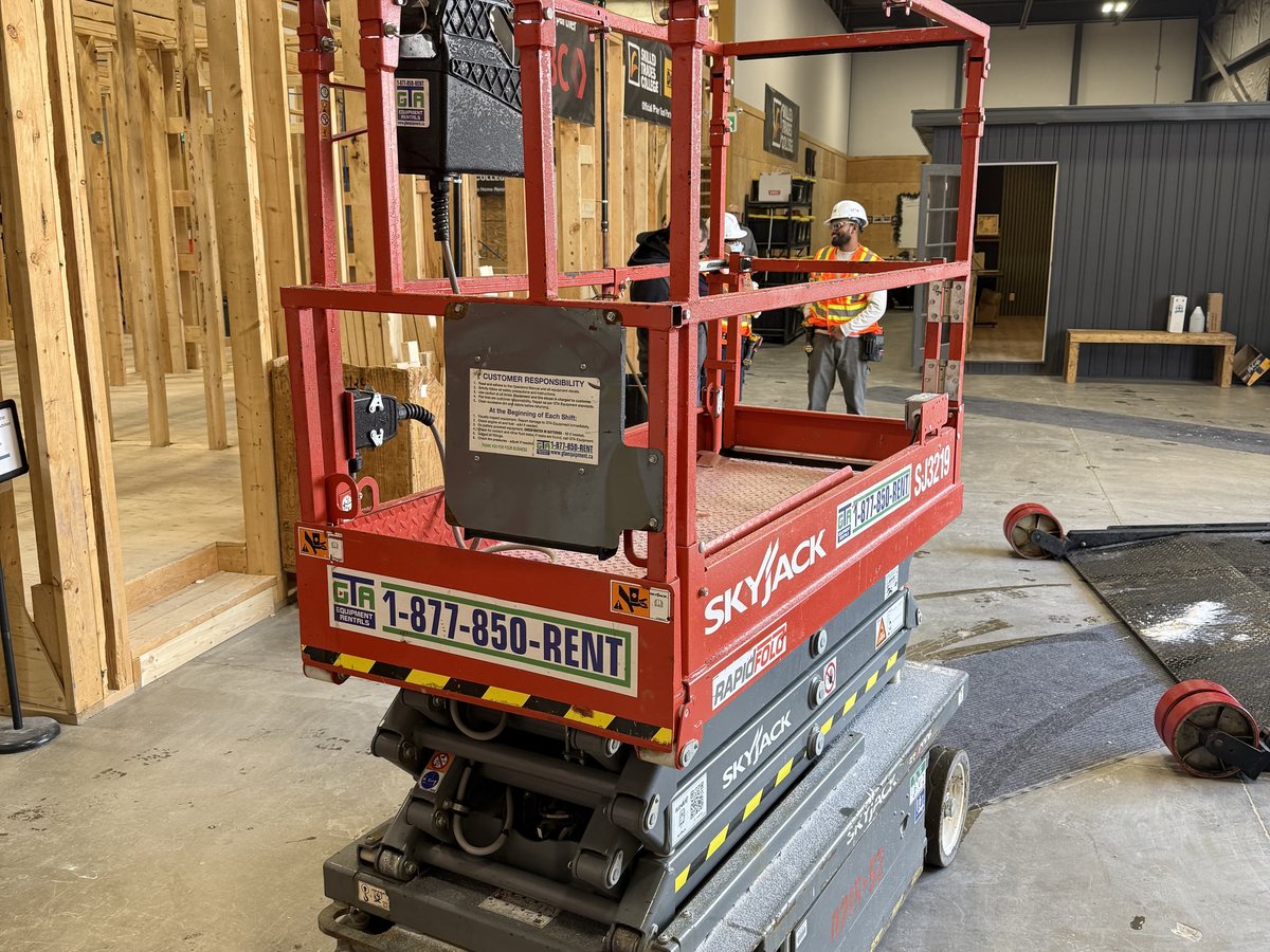 Skyjack scissor lift working inside a building under construction