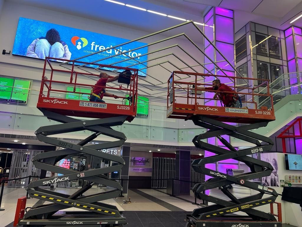 Two Skyjack scissor lifts on an interior fit-out inside a Toronto shopping centre