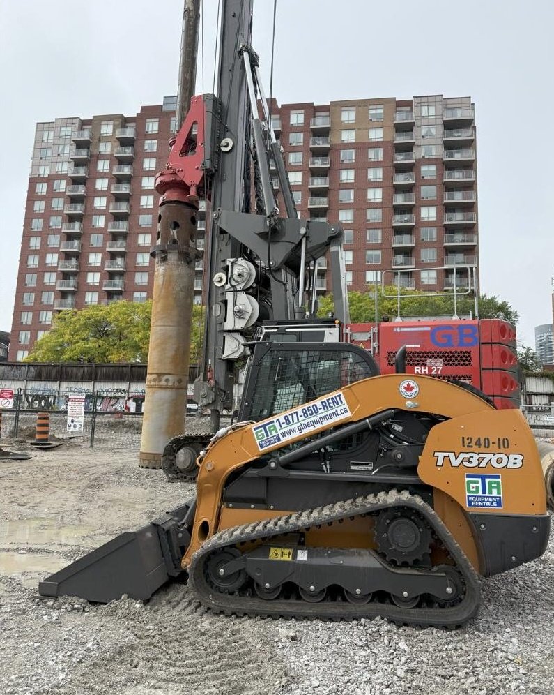 Case TV370B track loader supporting a piling rig on a downtown highrise job