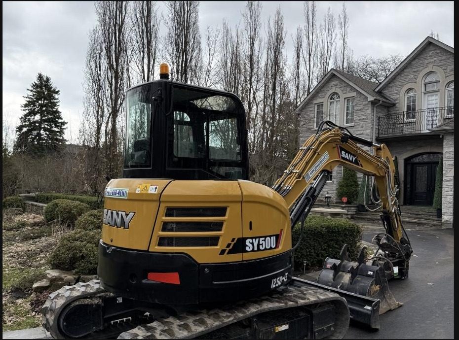 SANY SY50U excavator on a residential driveway job